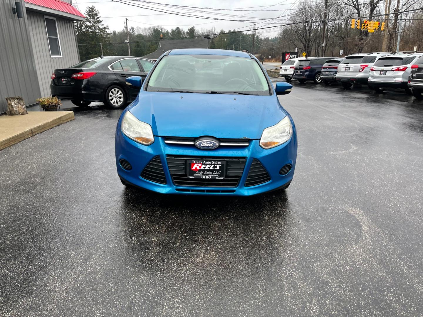 2014 Blue /Black Ford Focus SE Sedan (1FADP3F2XEL) with an 2.0L I4 DOHC 16V FFV engine, 6-Speed Automatic transmission, located at 547 E. Main St., Orwell, OH, 44076, (440) 437-5893, 41.535435, -80.847855 - Photo#1